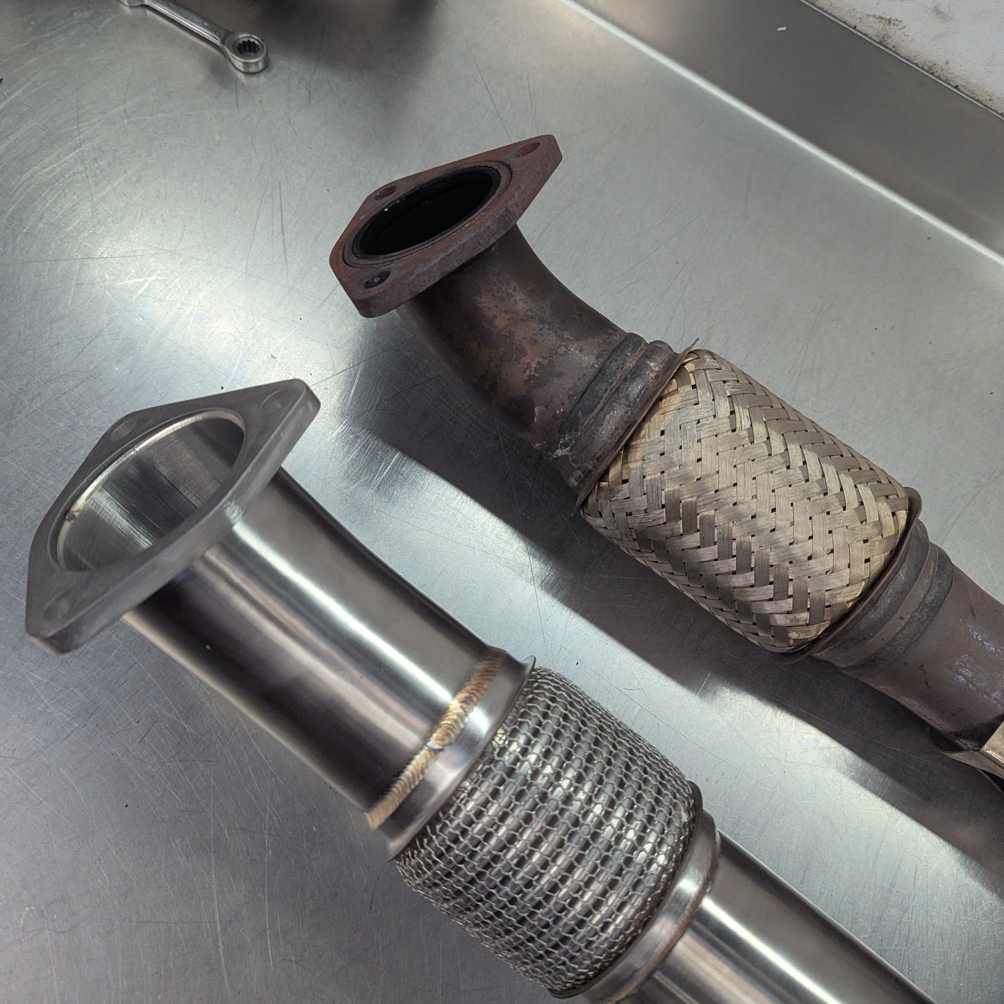Metal exhaust pipes on a metallic surface