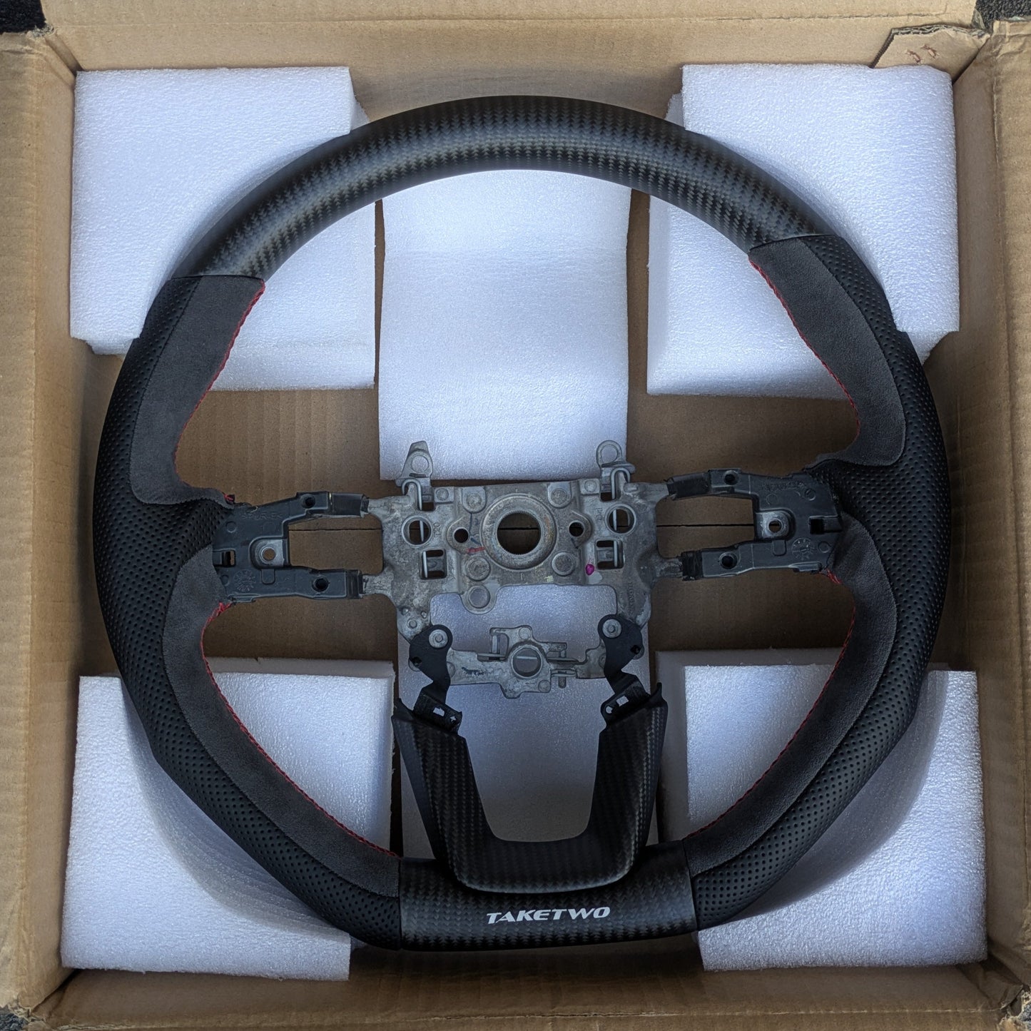 Steering wheel in a cardboard box with protective foam