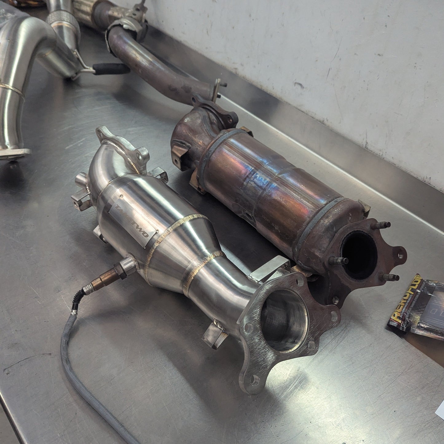 Exhaust pipes and catalytic converters on a metal surface
